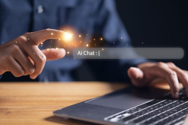 Businessman,Using,A,Laptop,With,An,Ai,Chat,Bot,Bubble