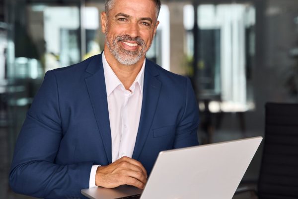 Vertical,Portrait,Of,Mature,Latin,Business,Man,Ceo,Trader,Using