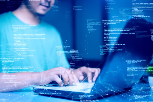 Man,Uses,A,Laptop,Computer,To,Log,In,To,An