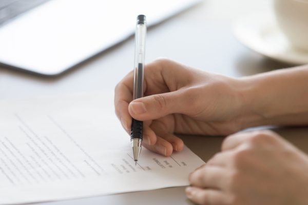 Businesswoman,Signing,Document,Concept,,Focus,On,Female,Hand,Holding,Pen,