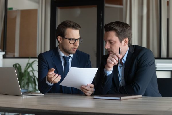 Serious,Young,Man,Supervisor,Analyse,Financial,Report,Of,Responsible,Worker